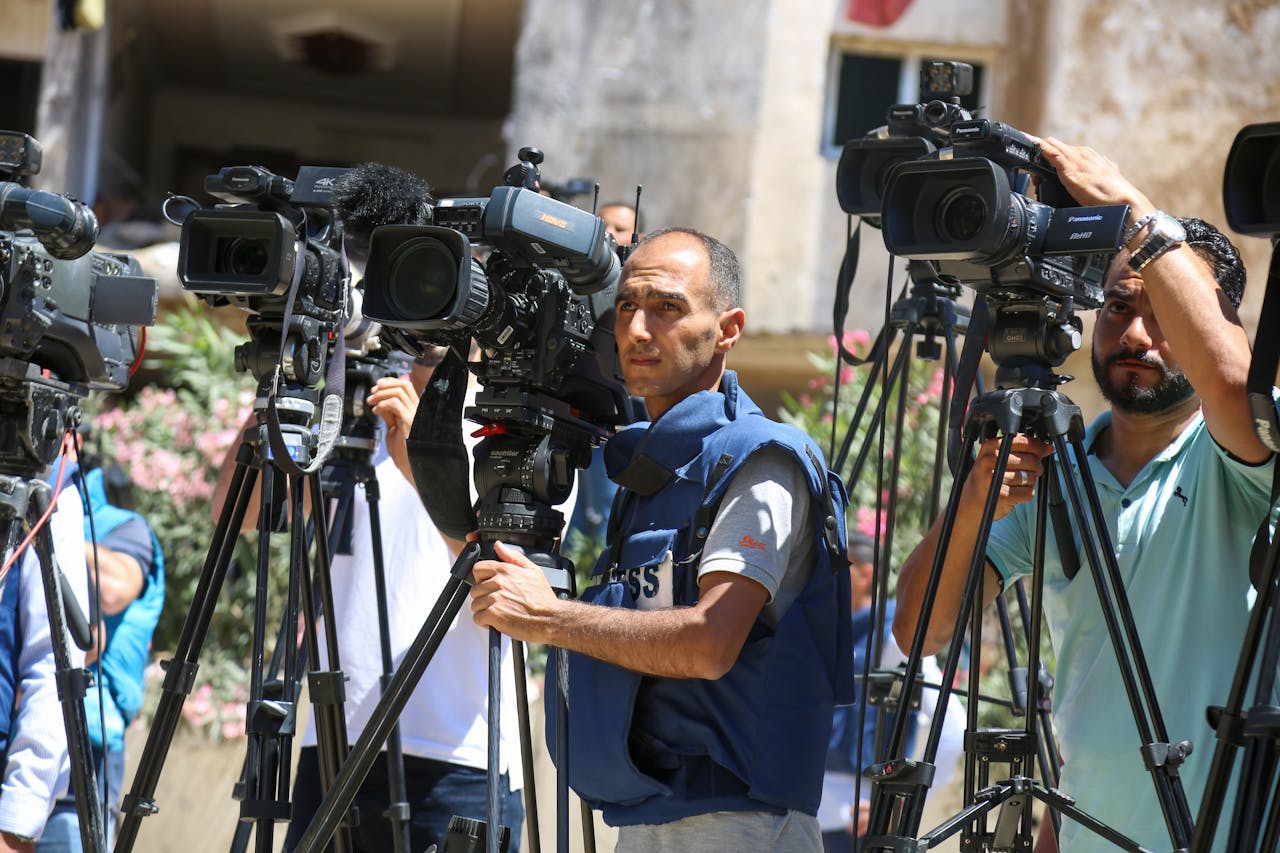 services-01 Journalists filming a live broadcast outdoors in Gaza Strip.